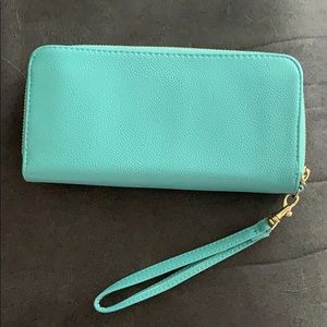 Teal wallet with gold zippers.